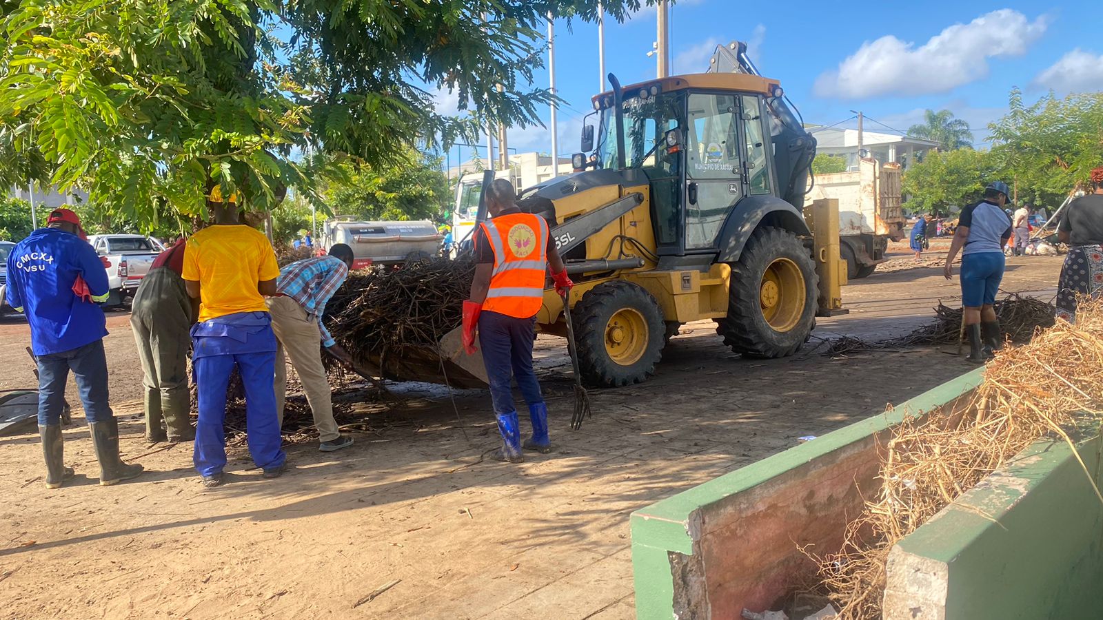Trabalhadores com retroescavadora municipal a remover entulhos e detritos das cheias em Xai-Xai